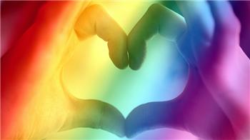 rainbow background with hands making a heart shape