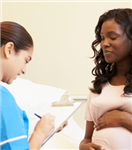 Image of pregnant person in conversation with healthcare professional